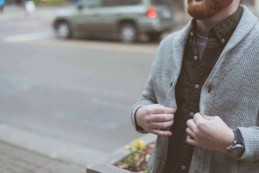 man holding his gray cardigan, man wearing gray button-up cardigan and black button-up collared shirt holding his cardigan at daytime HD wallpaper