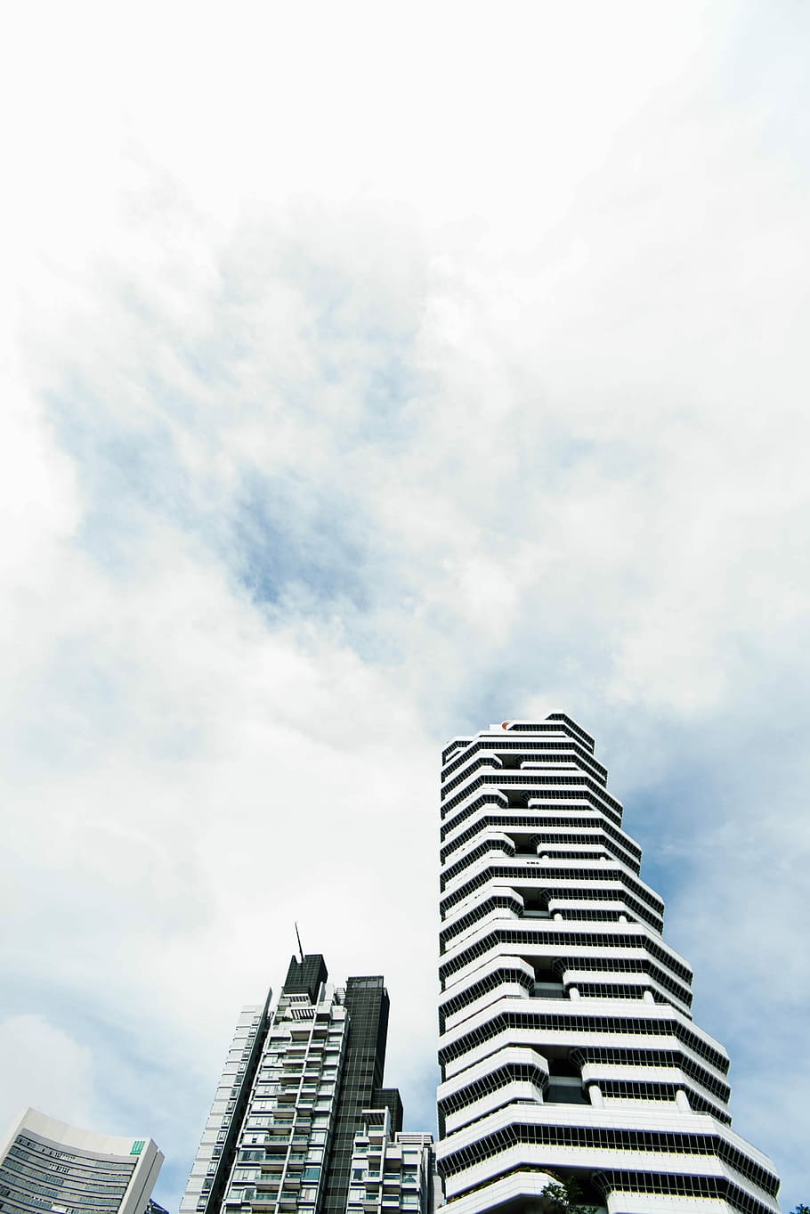 worm's eye view of buildings on a cloudy day, low-angle photo of high-rise buildings HD wallpaper