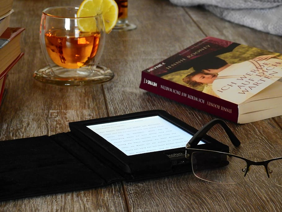 eyeglass beside e book reader and book on brown wooden surface HD wallpaper