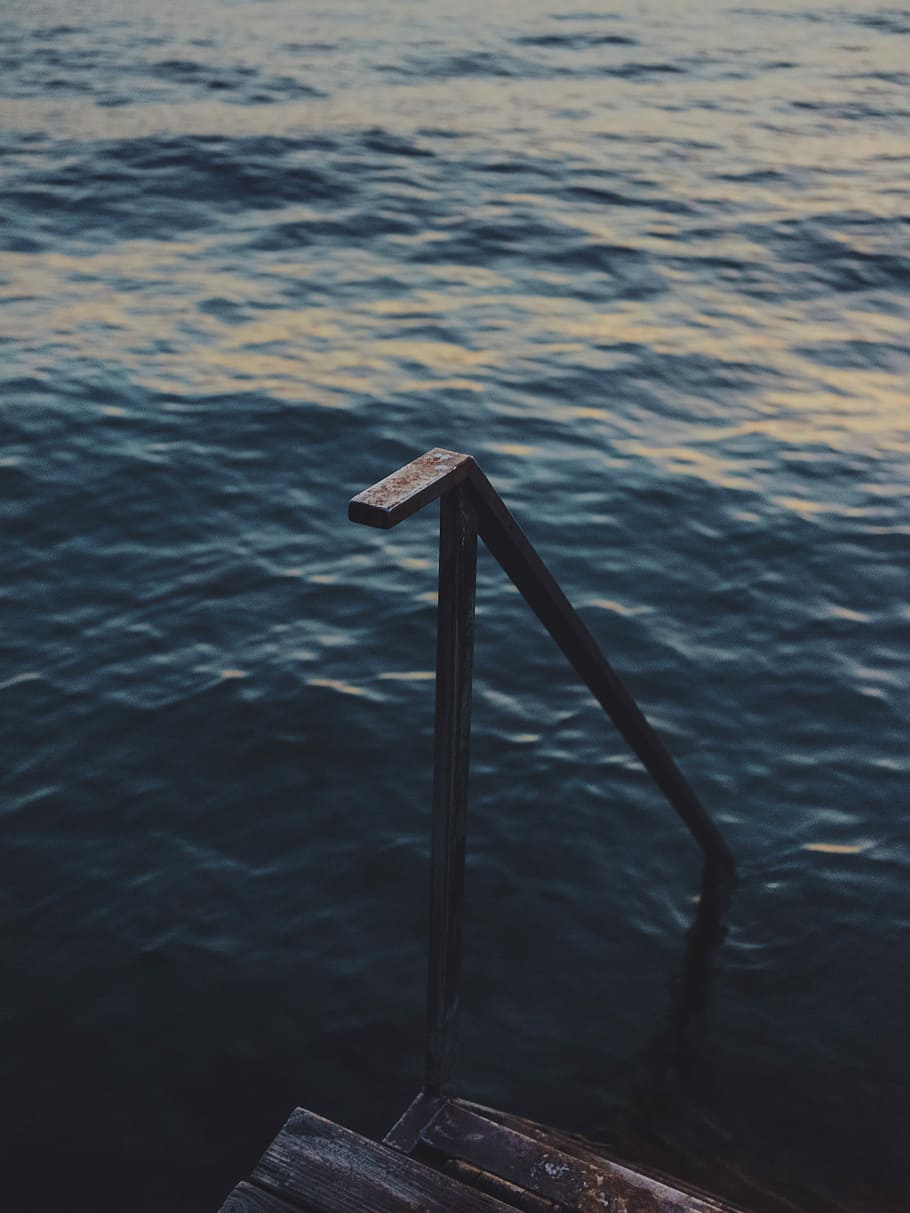 black metal railing with brown wooden stairs on body of water at daytime HD wallpaper