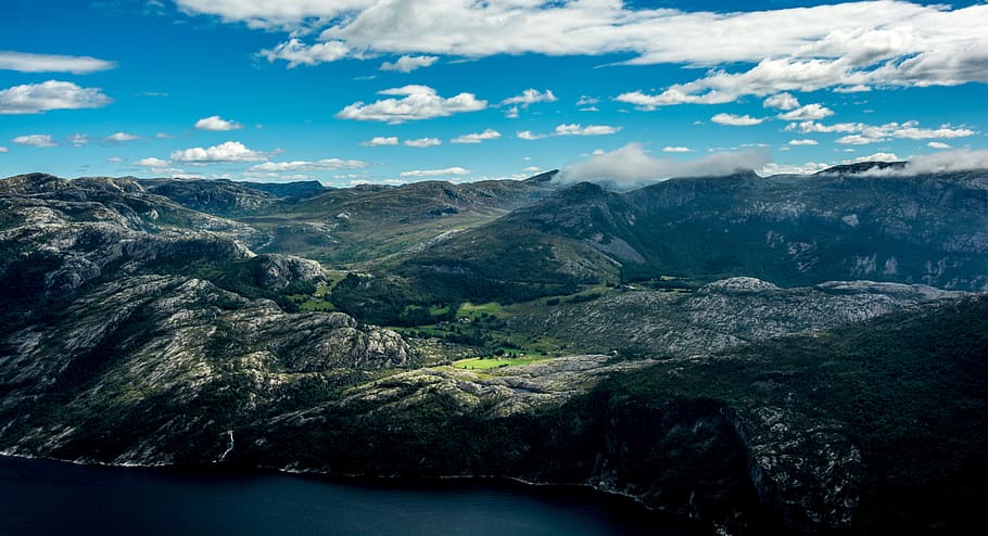 aerial photography of mountain, aerial view of gray and green mountain near body of water HD wallpaper
