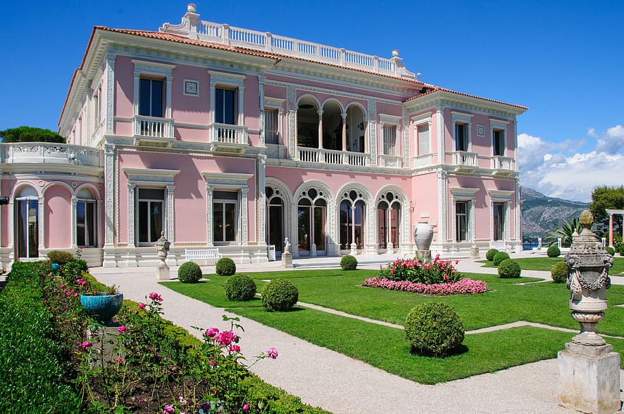 photo of pink and white painted house at daytime, villa, ephrussi