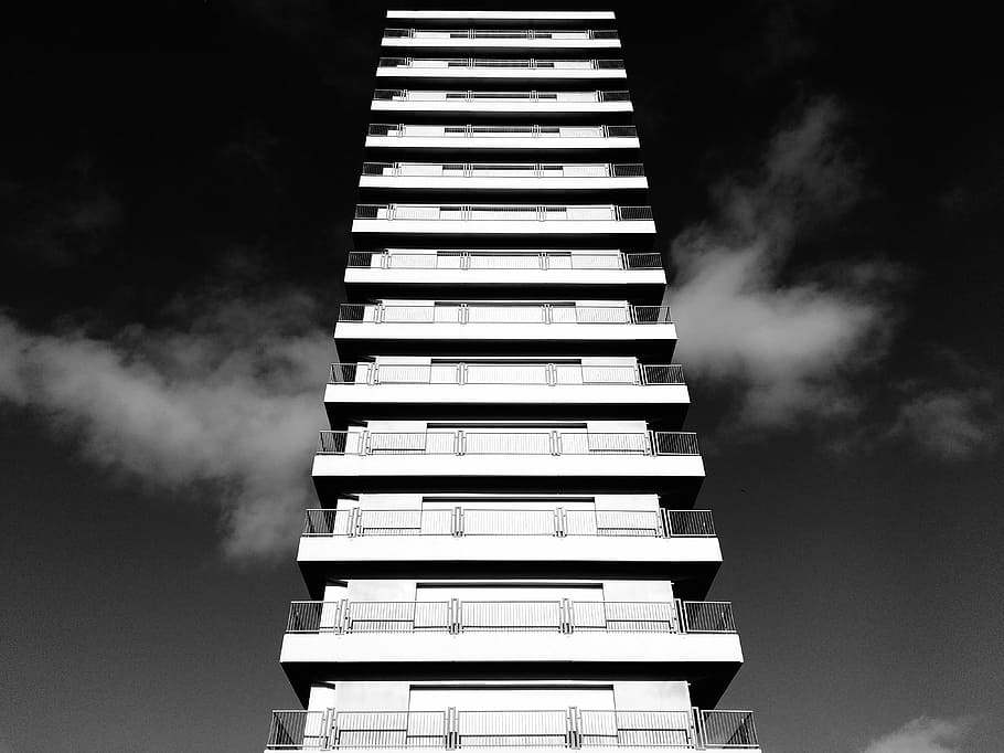 white concrete high rise building on sunny day grayscale photo HD wallpaper