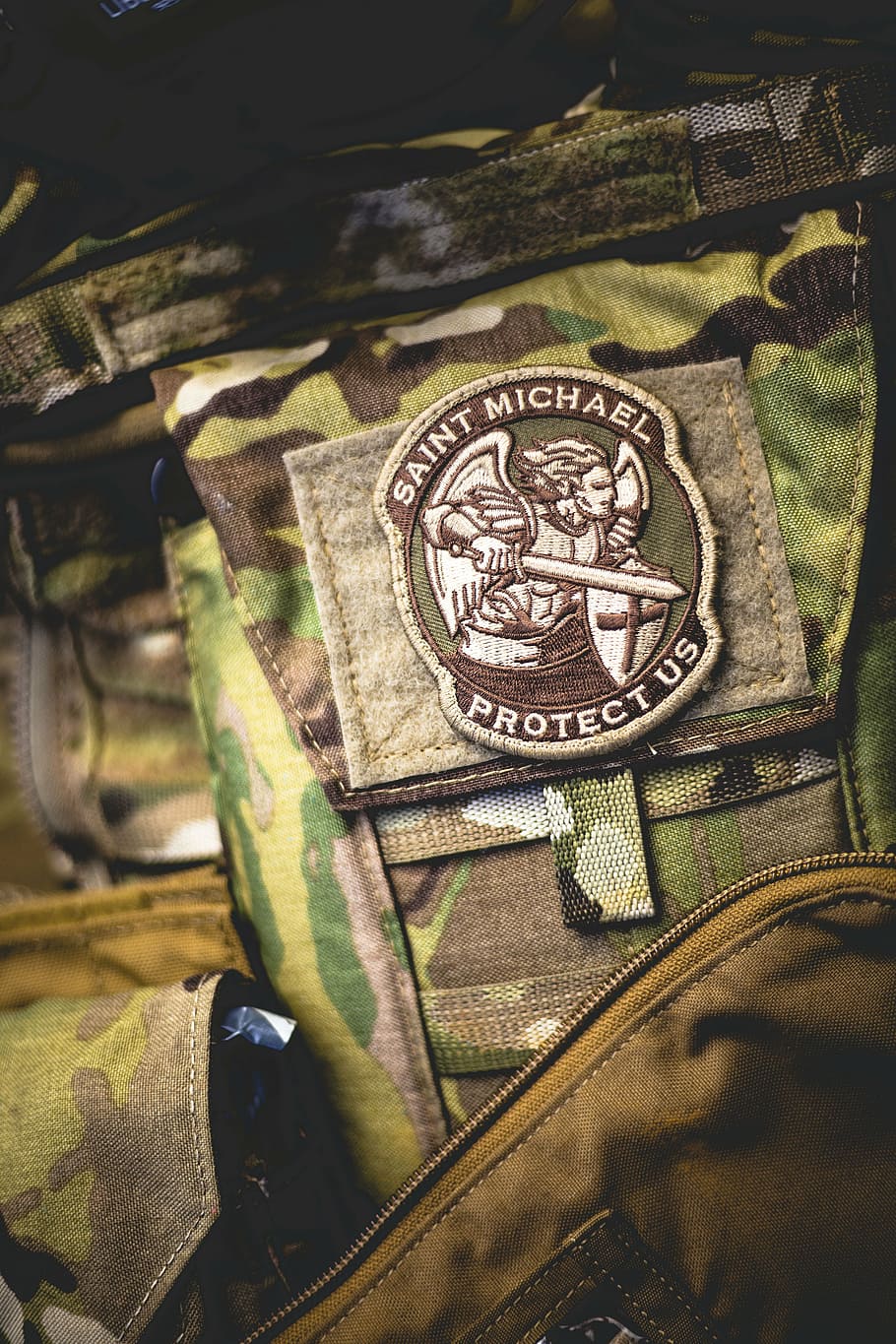 Saint Michael Protect Us patch insignia on green camouflage pants