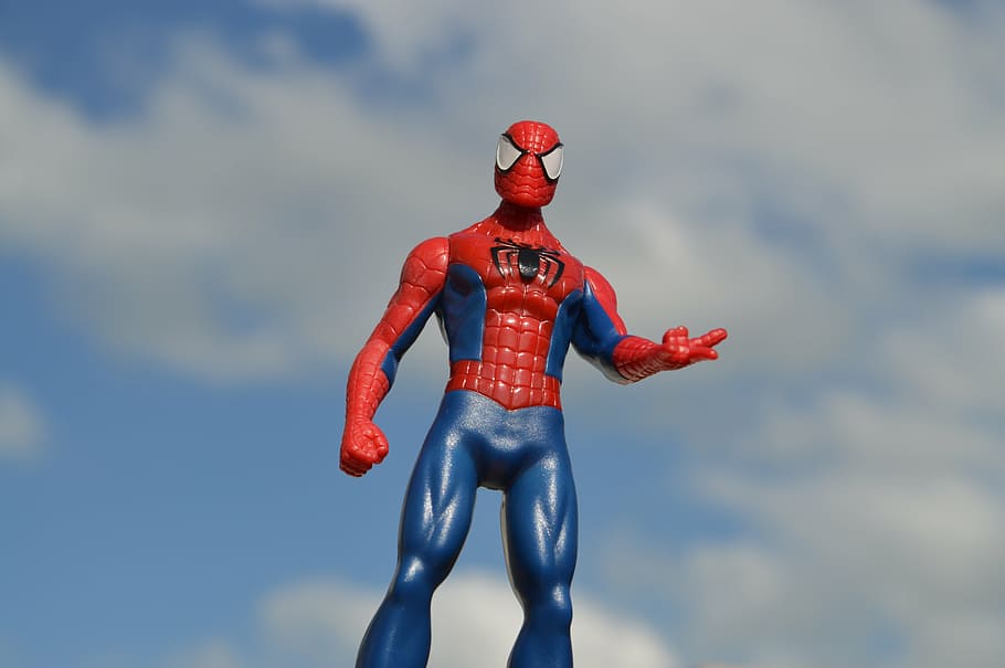 Spider-Man action figure under blue and white cloudy sky, spiderman