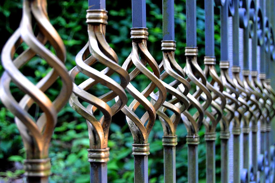 focus photo of gray and black metal gate, iron gate, wrought iron