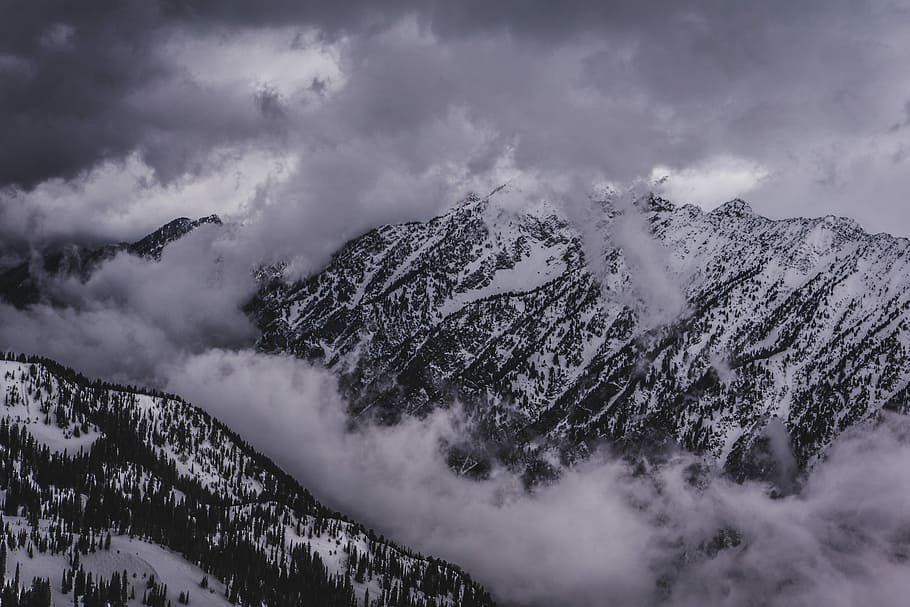 mountains covered with snow, snow covered mountains under white cloudy sky during daytime