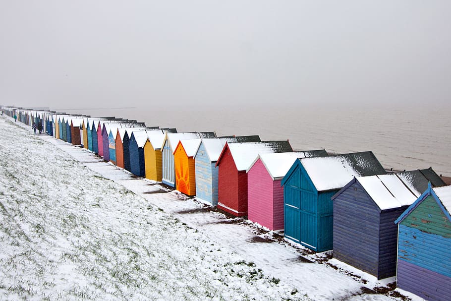 Winter-time snow covered scene of some beach huts on the Kent Coast in England HD wallpaper