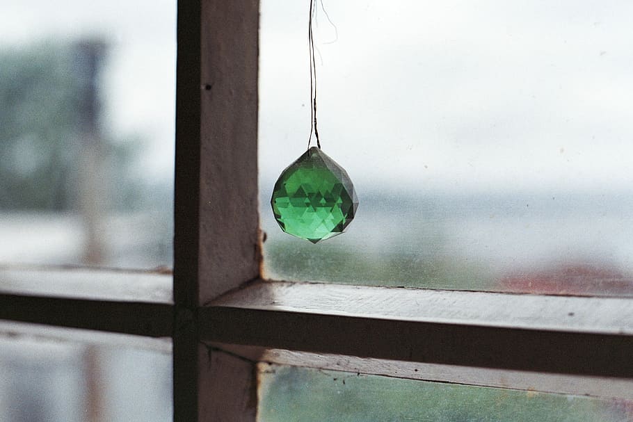 photo of hanging green stone near window, green gemstone hanging on clear glass window HD wallpaper