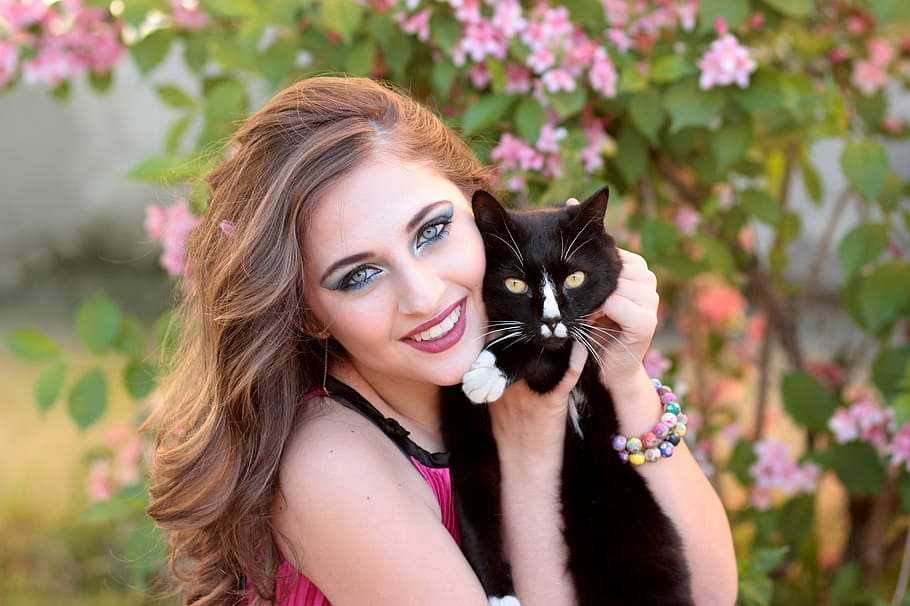 woman wearing pink top holding black cat, girl, love, hug, beauty
