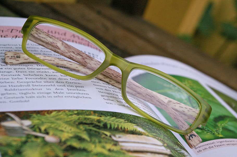 eyeglasses with green frame on top of magazine, see, overview
