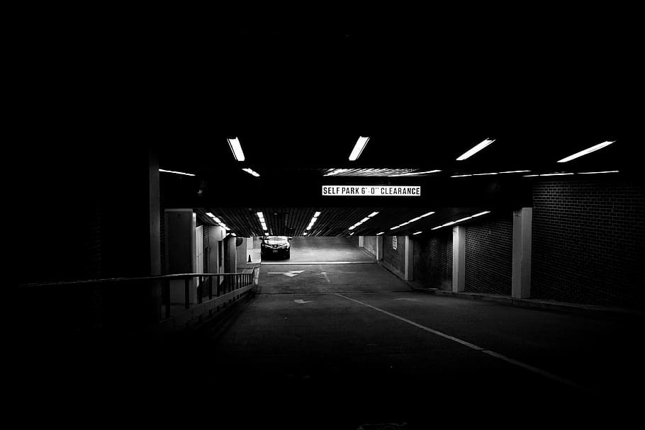 grayscale photo of parking area, grayscale photo of underground parking lot