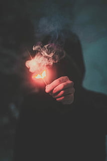 person wearing hoodie holding firecracker, flame, smoke, stick HD wallpaper