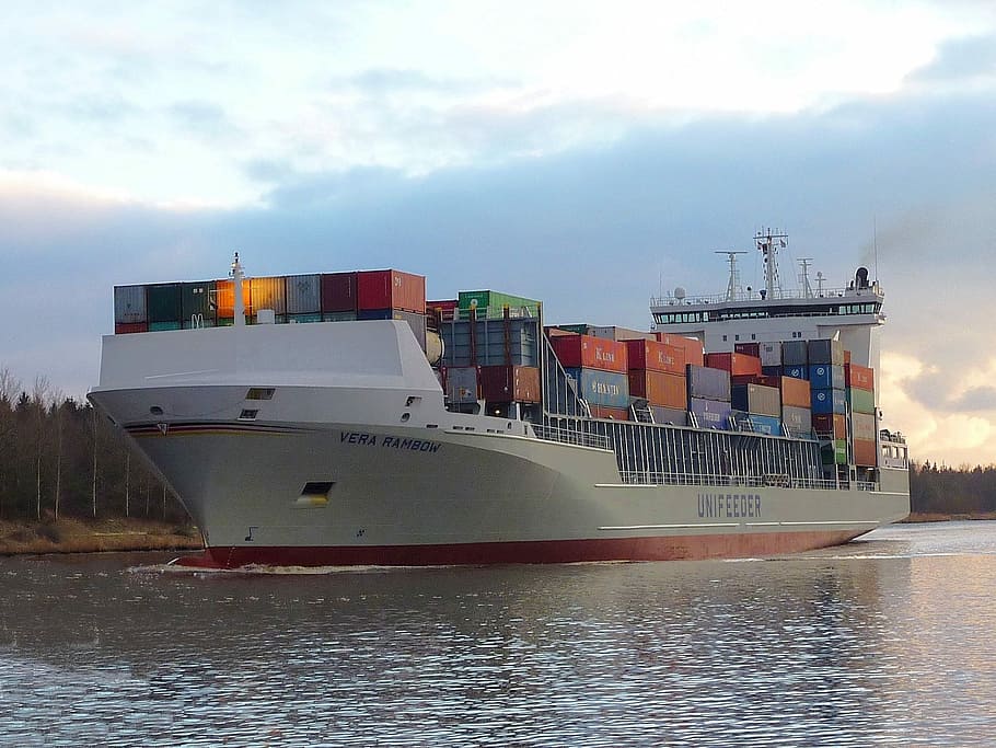 cargo ship with container loaded and surrounded by body of water HD wallpaper