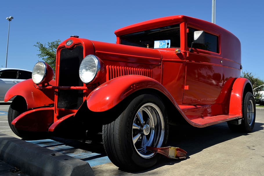 selective focus photography of classic red vehicle, restored