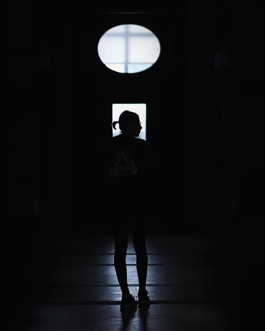 silhouette of a standing person, person standing near window
