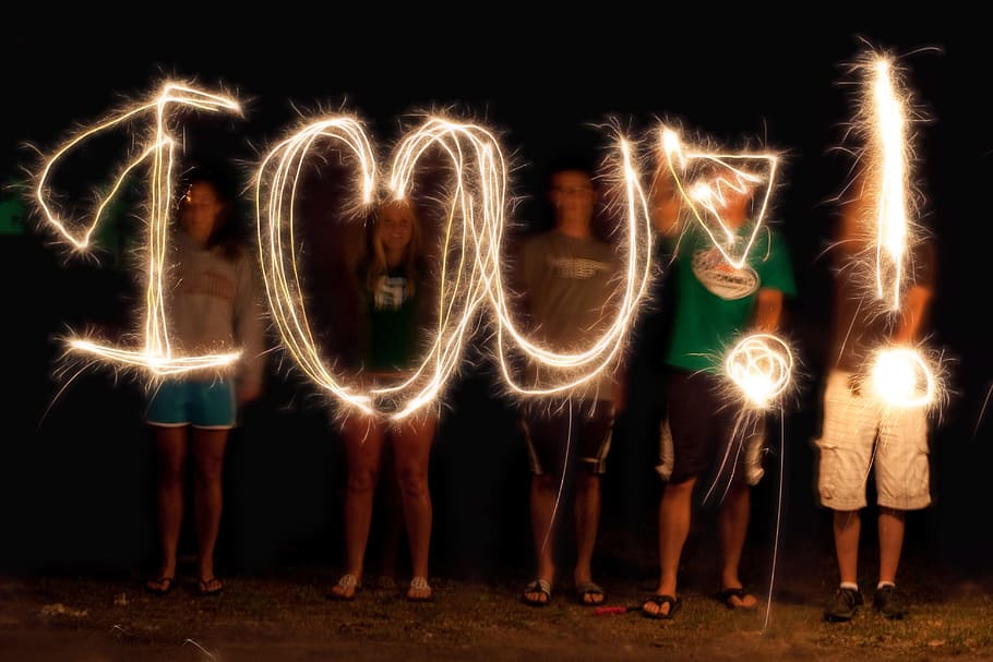 group of person doing i love you time lapse light photography
