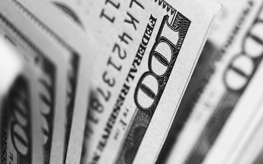 closeup photo of 100 US dollar banknotes, grayscale photography of 100 U.S. dollar banknote