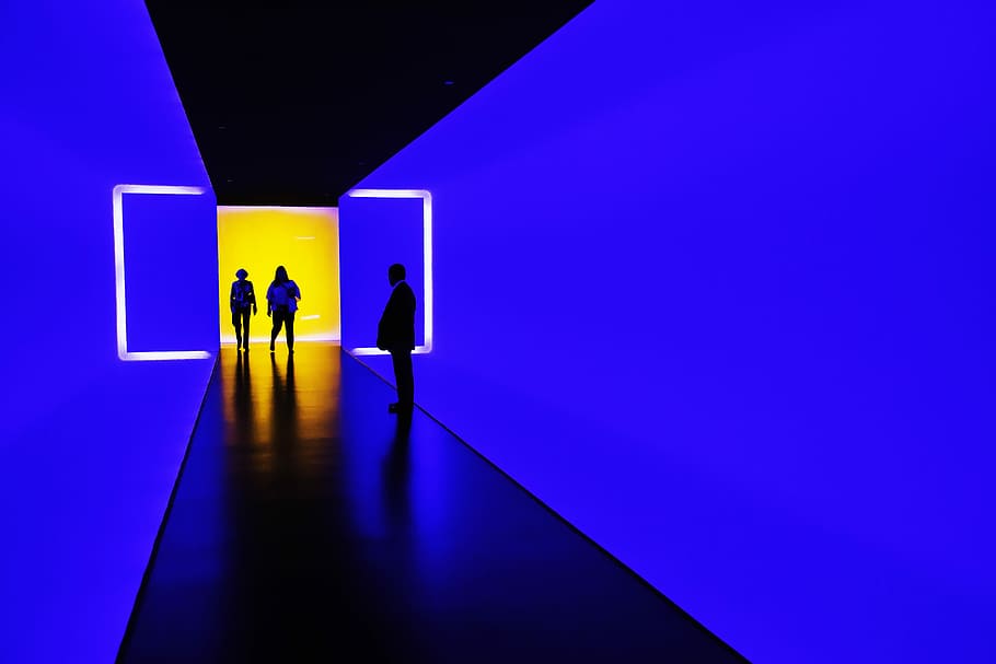 three person standing near wall inside building, three person standing near LED screen HD wallpaper