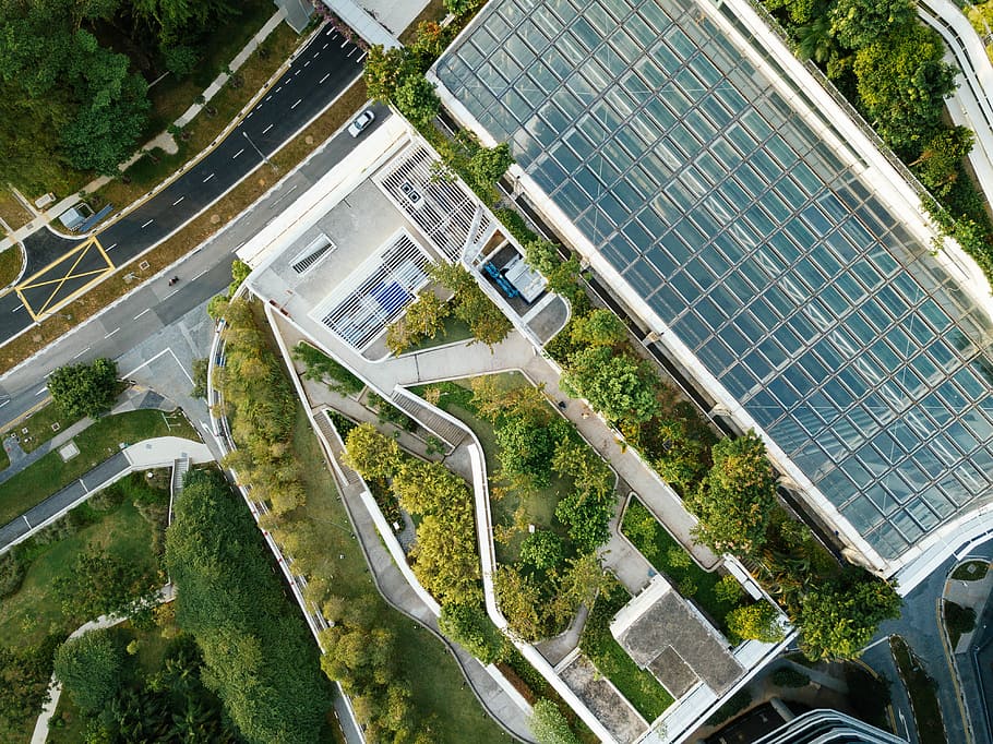 areal view photography of concrete road, aerial photography of commercial building surrounded by trees HD wallpaper