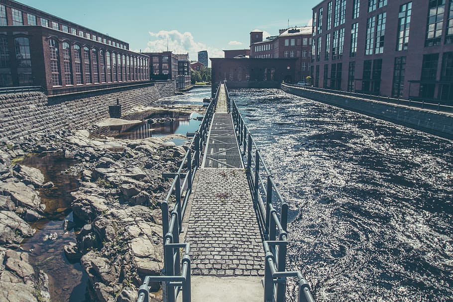 black metal bridge in the middle of water, near, buildings HD wallpaper