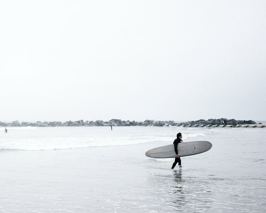 man carrying long surfboard while walking on water, sea, ocean HD wallpaper