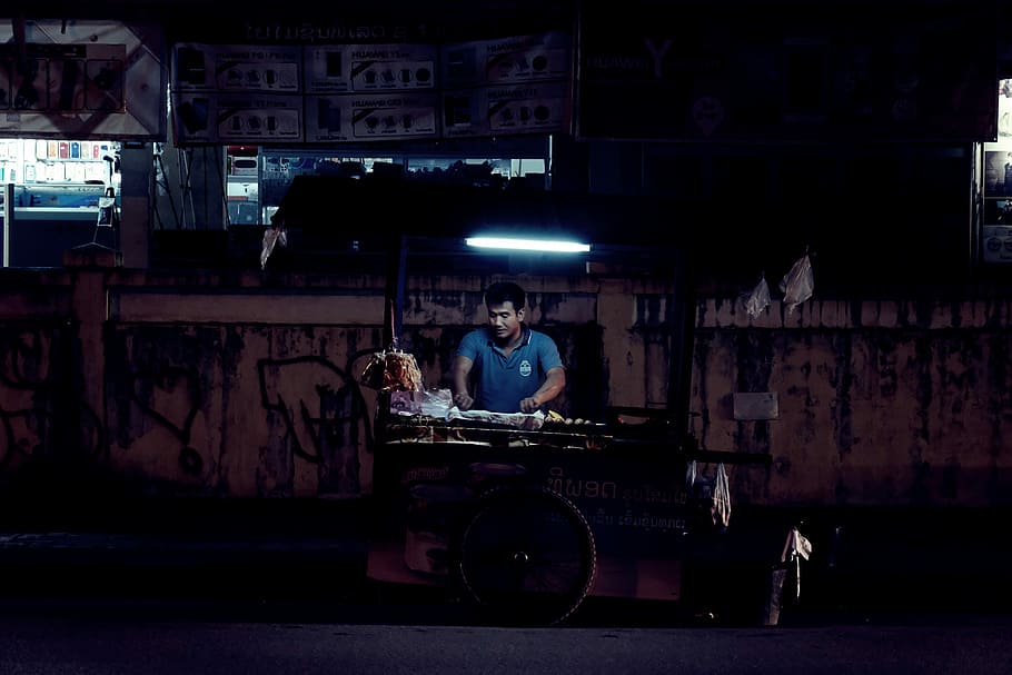 man standing beside food stand, man standing near street cart HD wallpaper