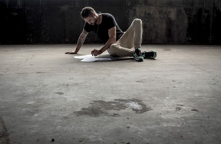 Man writing on concrete floor, man sitting on ground while making artwork, HD wallpaper