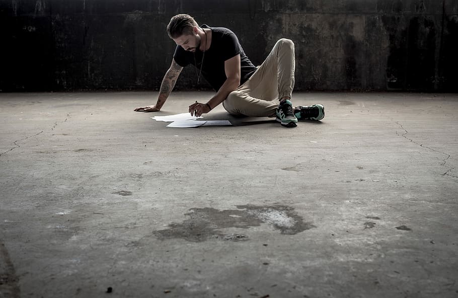 Man writing on concrete floor, man sitting on ground while making artwork HD wallpaper