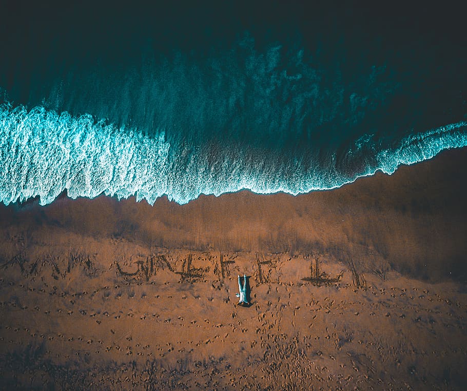 bird's eye view of man lying down on seashore, man lying on seashore aerial photography, HD wallpaper