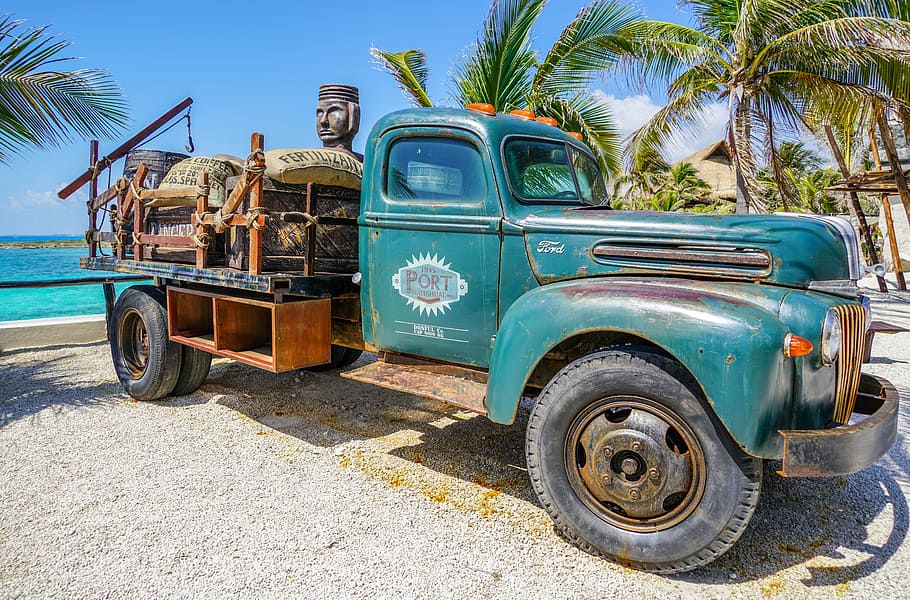 classic blue single cab truck parked beside seashore, antique
