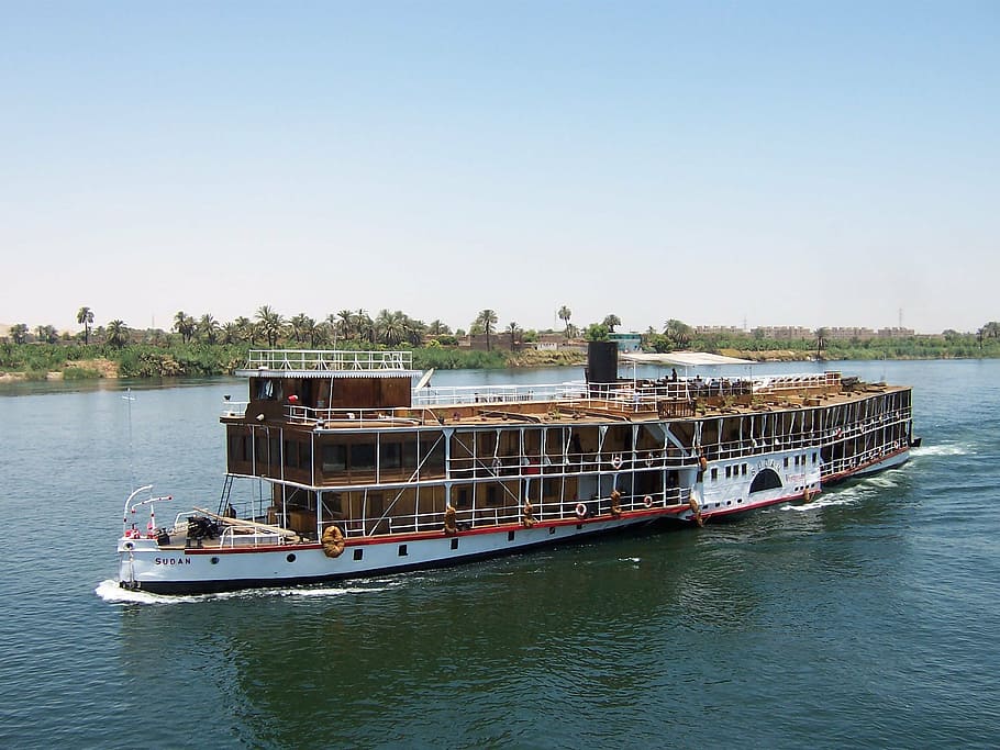 white and brown cruise ship traveling on body of water, nile