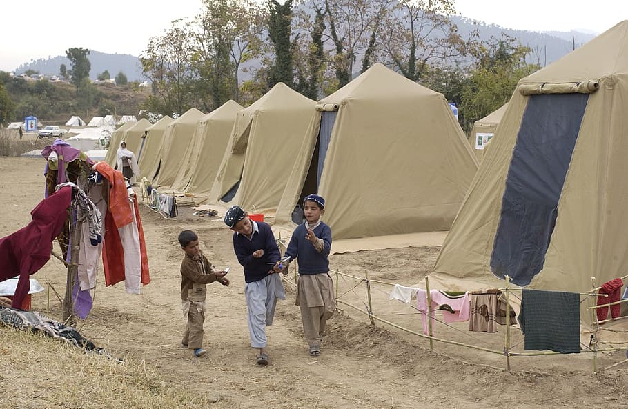 three boy nearby brown tent, shinkiari, pakistan, camp, tents