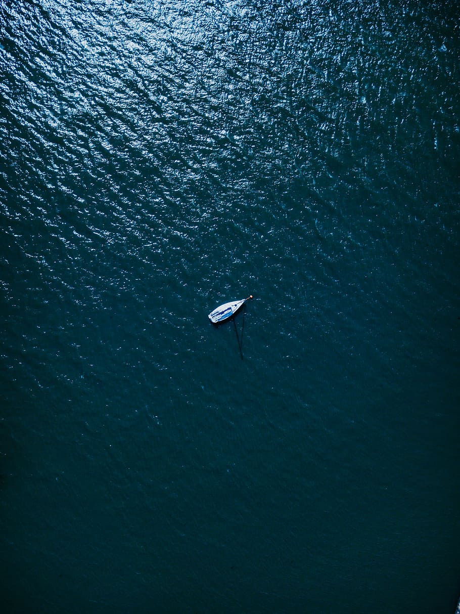 aerial photography of white boat on body of water at daytime, white boat in the middle of the sea during daytime