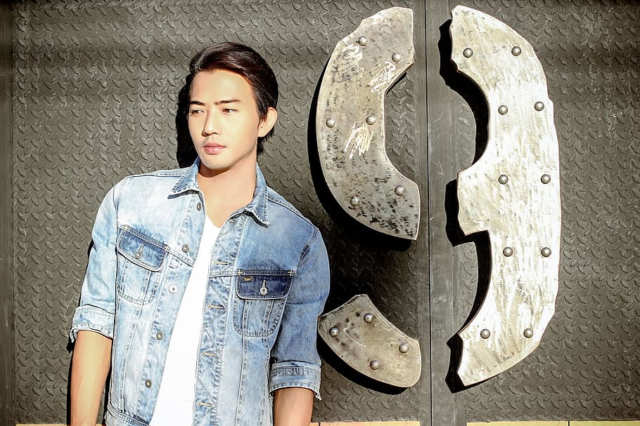 man in blue denim dress shirt and white crew-neck shirt standing beside number 9 wall decor HD wallpaper