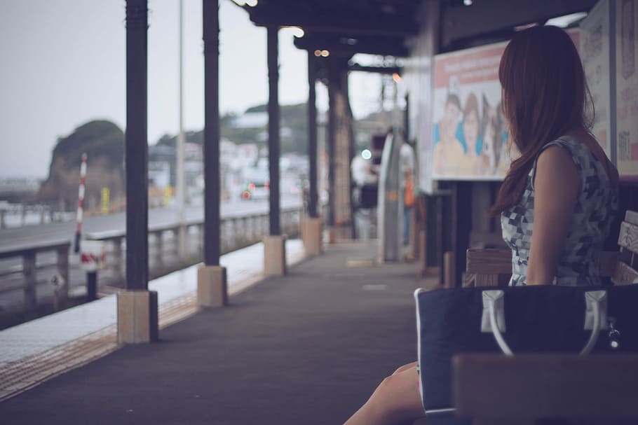 selective focus photography of woman wearing white and gray digital camouflage sleeveless mini dress sitting on brown wooden bench HD wallpaper