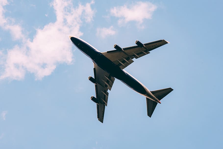 low angle photography of airplane on the sky, gliding airplane under blue and white cloudy skies at daytime HD wallpaper