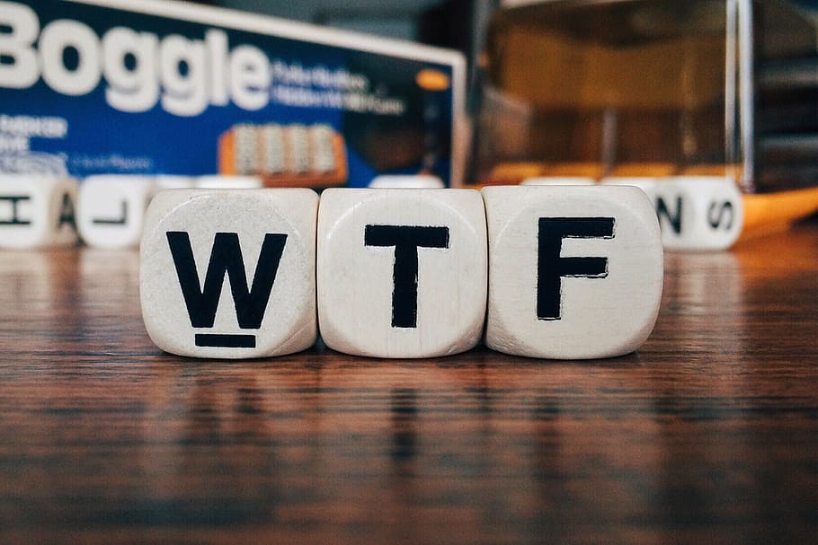 WTF word boggle blocks on brown wooden surface, texting, social media