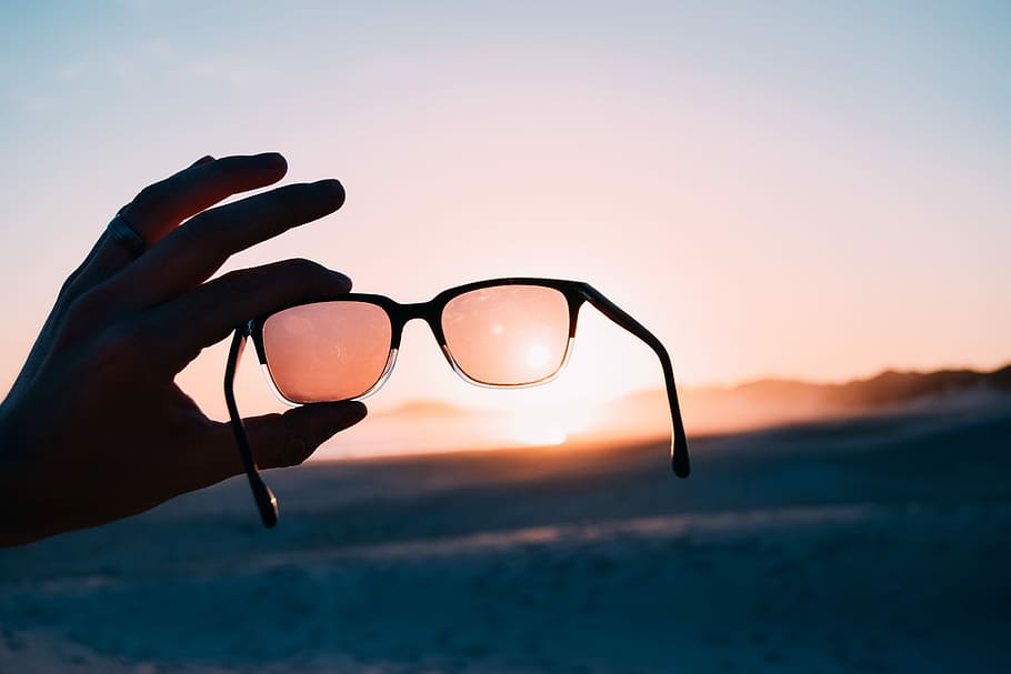 person holding Wayfarer-style sunglasses, person holding gray sunglasses with black frames under sunset, HD wallpaper