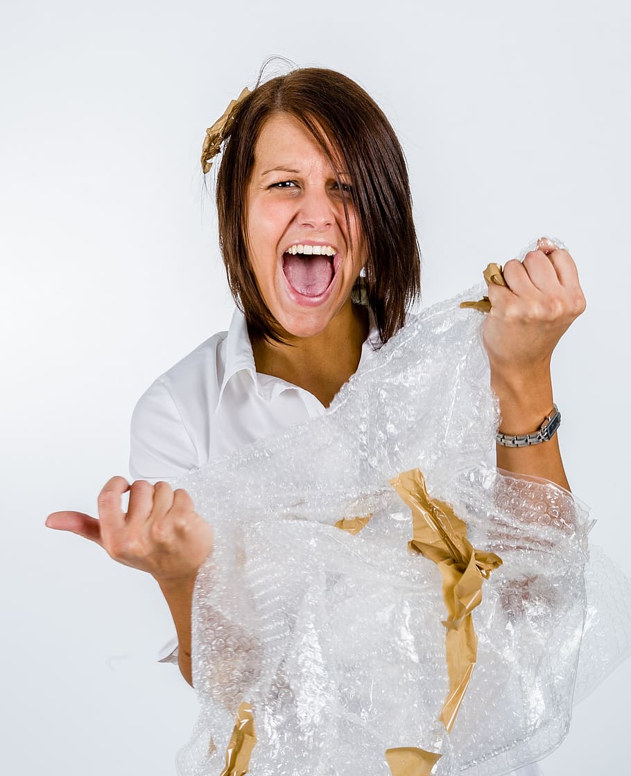 woman shouting while holding white textile, office, packaging