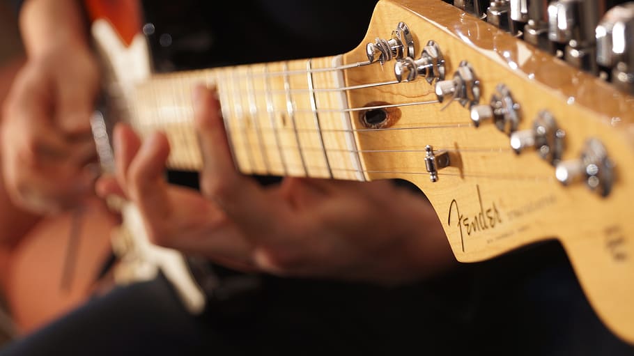 person playing brown Fender electric guitar, Fender, Stratocaster