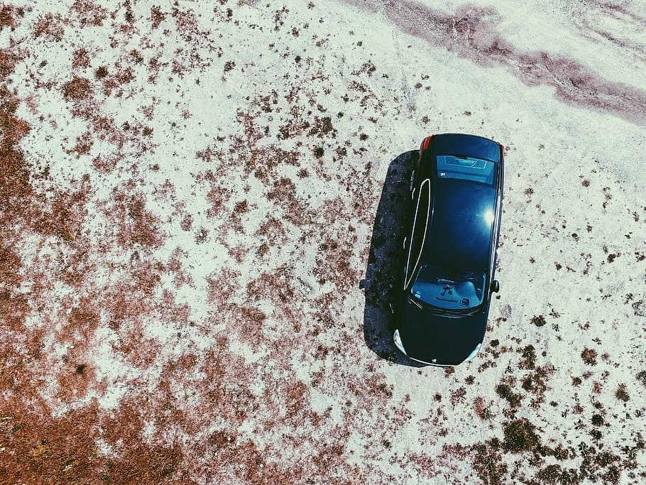 black car on white surface, black coupe at gray concrete floor during daytime HD wallpaper