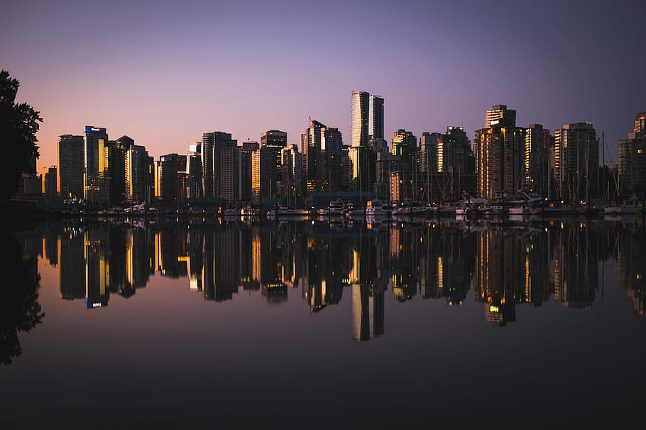 city skyline near water, reflective photography of cityscape by water HD wallpaper