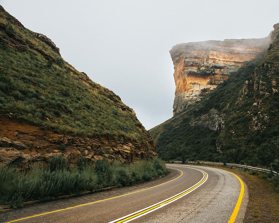 gray paved highway in between of mountain, concrete road between hills HD wallpaper