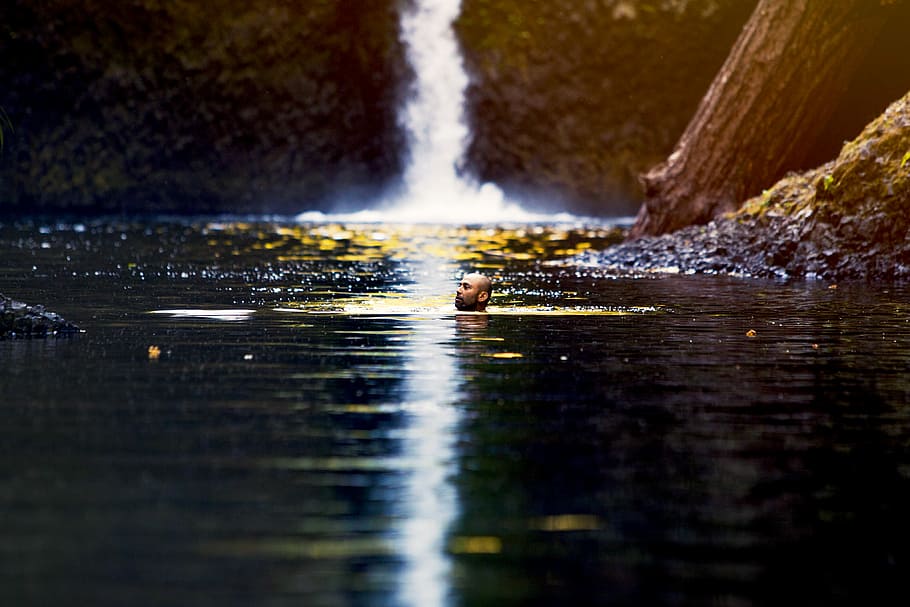 man swimming on waterfall puddle, man under the body of water HD wallpaper