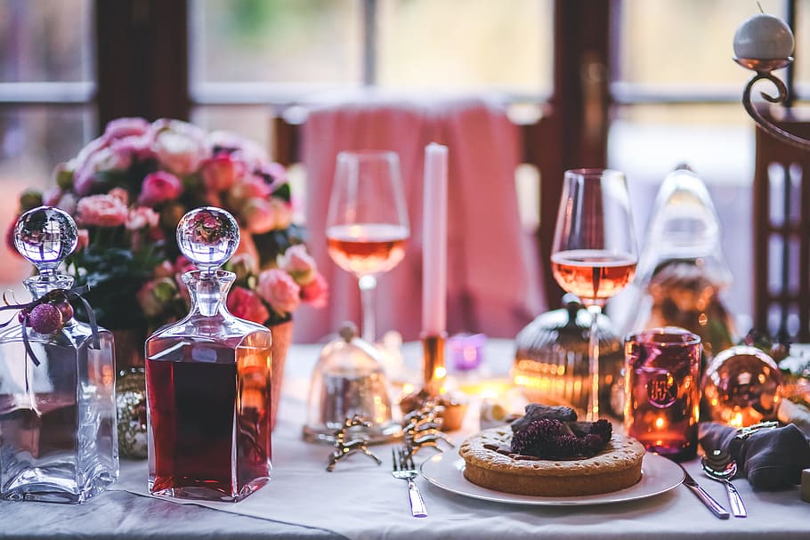 two glass decanter filled with wine on table with plate of pies and wine glasses HD wallpaper