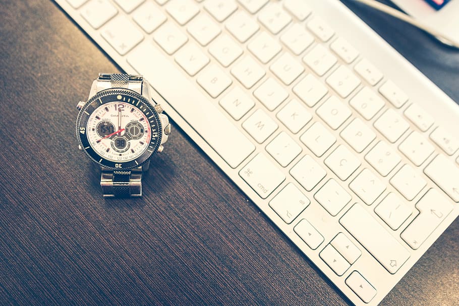 chronograph watch beside Apple Wireless keyboard on wooden surface HD wallpaper
