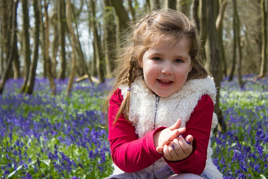 girl wearing red jacket sitting beside purple flowers at daytime, HD wallpaper