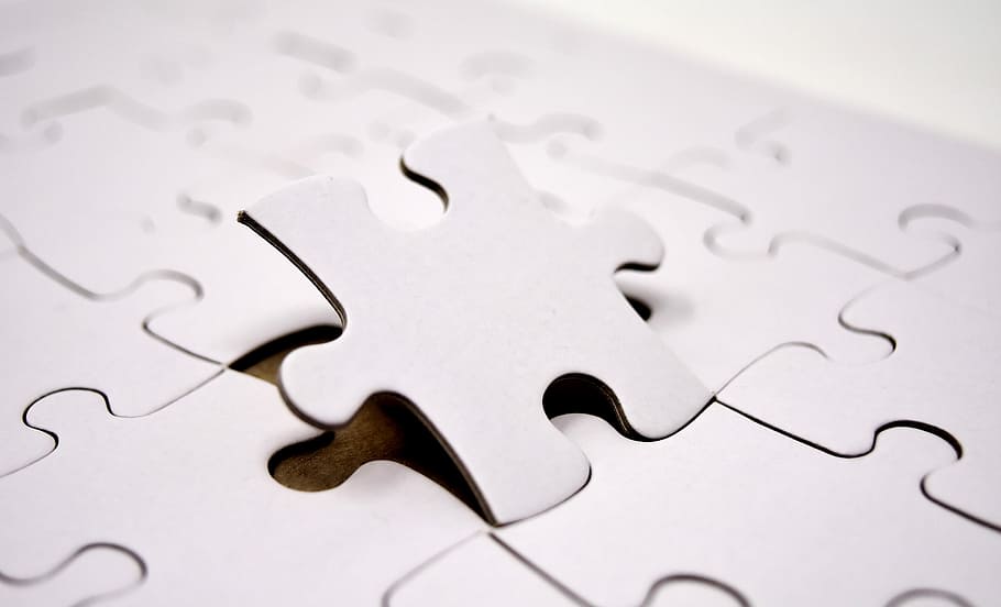 selective focus photo of a jigsaw puzzle, last part, joining together
