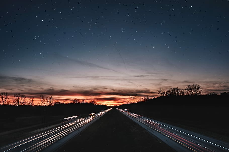 silhouette of trees during sunset, time lapse photography of concrete road HD wallpaper